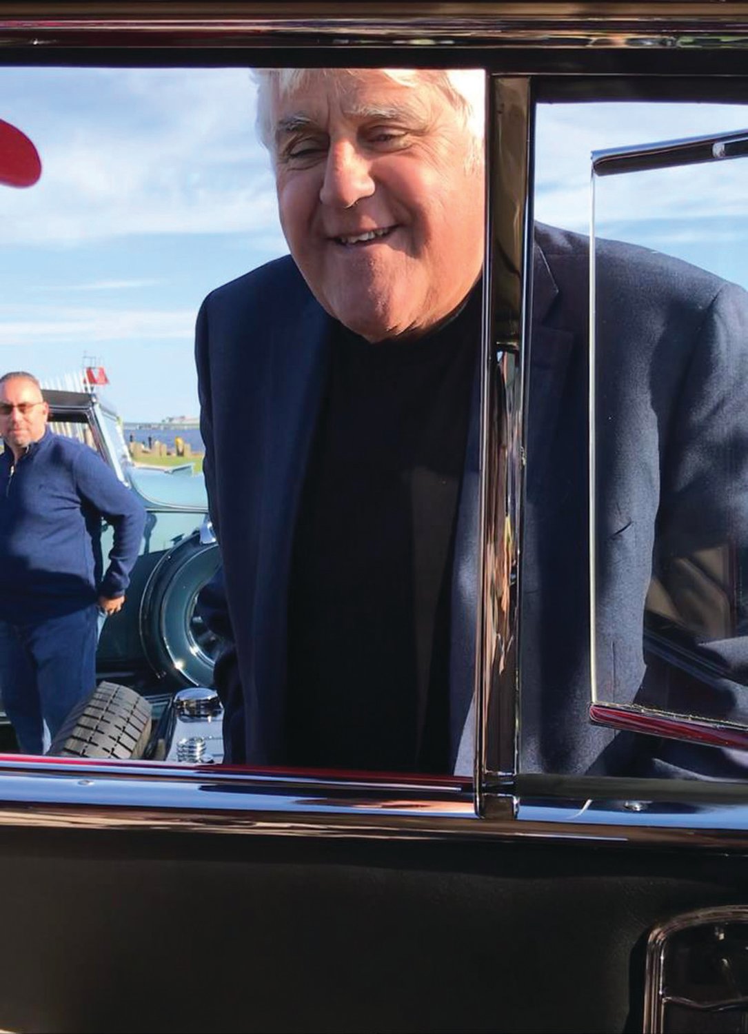 WHAT'S NEW, WHAT'S HAPPENING? Jay Leno poked his head through the window of John Ricci’s 1934 Cadillac during this year’s Concours d’Elegance in Newport.